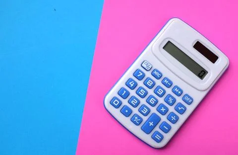 Copy space A blue calculator on the two tone color blue and pink background Stock Photos