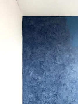 Copy space on a blue textured wall surface and finishing process Stock Photos