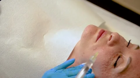 Copy space. Close up Cosmetologist makes injections in skin of beautiful girl Stock Footage 254359400