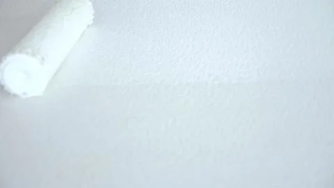 Copy space. close-up paint roller paints the surface with white paint Stock Footage 185708379