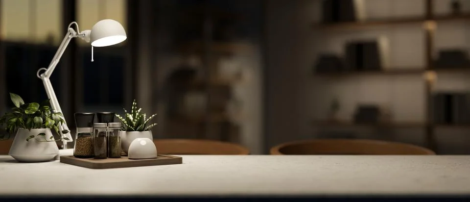 A copy space on a dining table under dim light from a lamp in a contemporar.. Foto stock