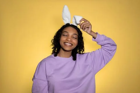 Copy space easter banner with cute girl in bunny ears having on yellow Stock Photos
