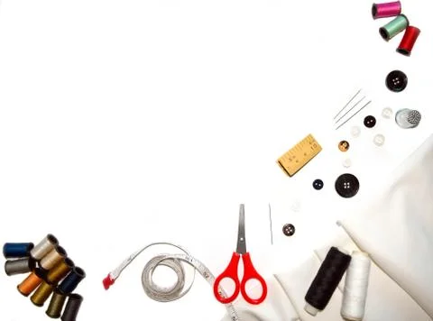 Copy-space frame with sewing tools and  fabric on white background Stock Photos