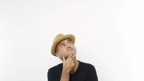  Copy Space, Guy put on hat in casual clothes touching chin, scratching head whi Stock Footage 144651270