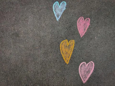 Copy space of hand drawn 4 colorful heart or love symbols. Using color chalk  Stock Photos