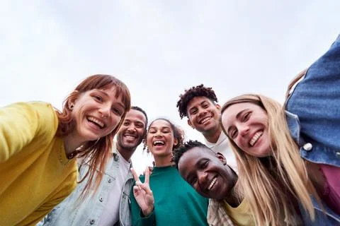 Copy space image of a multicultural group of friends taking a selfie, looking Stock Photos