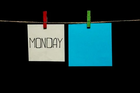 Copy space. Monday. Note is written on a white sticker. Two sheets of paper Stock Photos