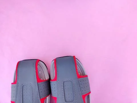 Copy space of one pair of grey and red color men sandals or slipper isolated  Stock Photos