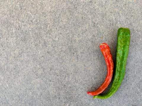 Copy space of one red and green chilli pepper isolated on grey background Stock Photos