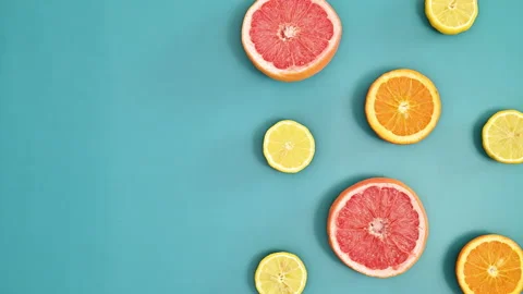 Copy space pattern on vivid blue background with citrus fruits. Stop motion Stock Footage 192508073