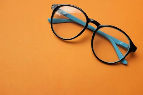 Copy space round black Eye Glasses isolate on a orange Background Stock Photos