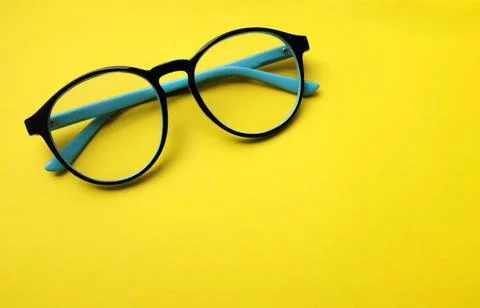 Copy space round black Eye Glasses isolate on a yellow Background Stock Photos