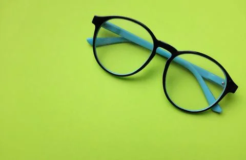 Copy space round black Eye Glasses isolate on a green Background Stock Photos