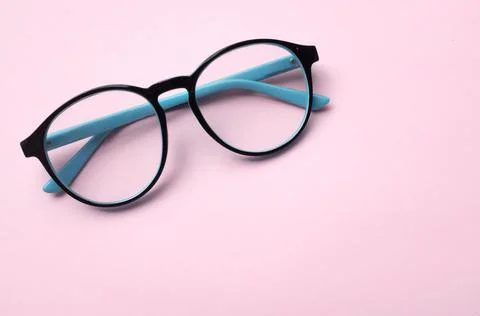 Copy space round black Eye Glasses isolate on a pink Background Stock Photos