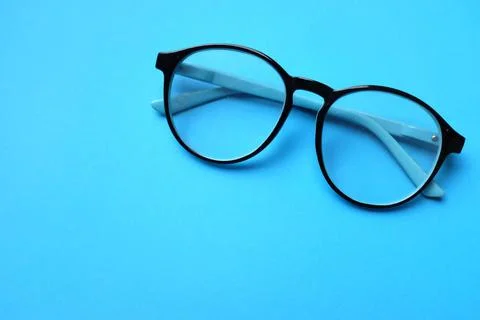 Copy space round black Eye Glasses isolate on a blue Background Stock Photos