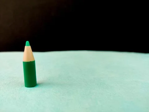 Copy space Small size green color pen or pencil or crayon on green and black  Stock Photos