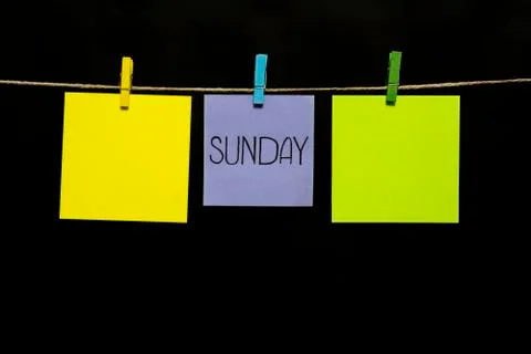Copy space. Sunday. Note is written on a gray sticker. Two yellow sheets and one Stock Photos