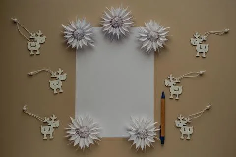 Copy space for text. Blank sheet of paper, pen and deers made of wood close.. Stock Photos