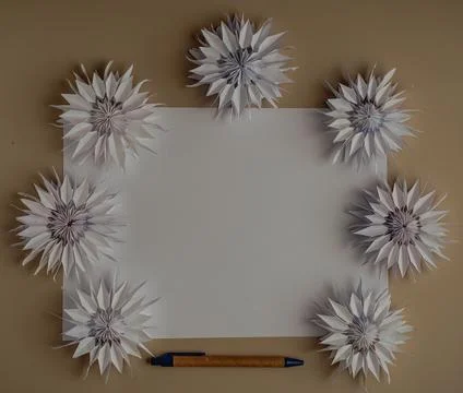 Copy space for text. Horizontalb lank sheet of paper, pen, 7 origami flower.. Stock Photos