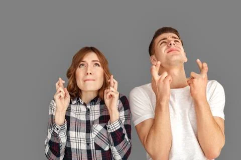 Copy Space for Text or Product. Young couple standing isolated on grey looking Stock Photos