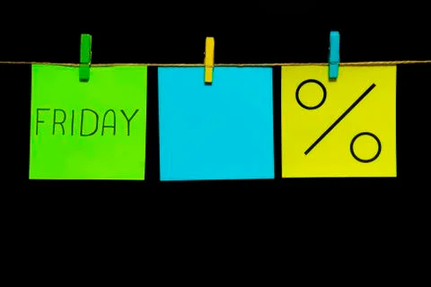 Copy space. Three stickers. On the left green sheet inscription Friday. In the Stock Photos