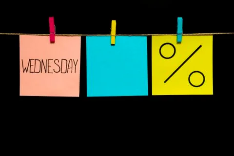 Copy space. Three stickers. On the left white sheet inscription Wednesday. In Stock Photos