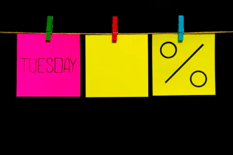 Copy space. Three stickers. On the left pink sheet inscription Tuesday. In the Foto stock