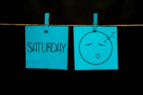 Copy space. Two multicolored stickers. On left a sheet inscription saturday. On 스톡 사진