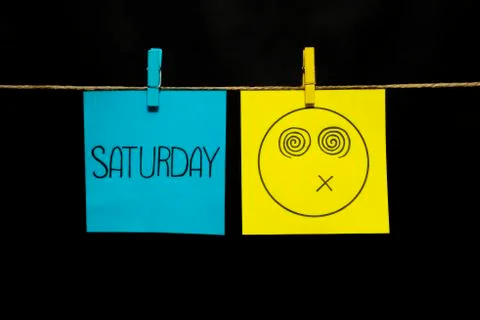Copy space. Two multicolored stickers. On left a sheet inscription saturday. On Stock Photos