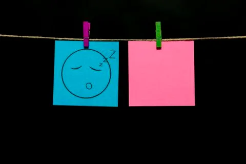 Copy space. Two stickers. Left on the azure sheet of face with an expression of Stock Photos