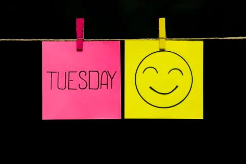 Copy space. Two stickers. On the left the inscription Tuesday. On yellow smiley Stock Photos