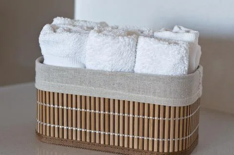 Copy space, white textile hand towels in bamboo box isolated Stock Photos