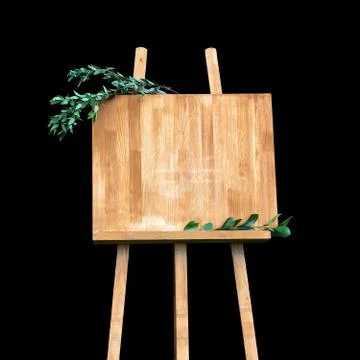 Copy space, your text here. Wooden easel with a board. Isolation on a black b Stock Photos