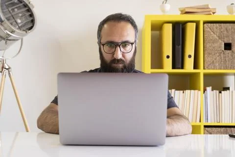 Copy writer of coder typing on laptop. Office worker focused on notebook. Stock Photos
