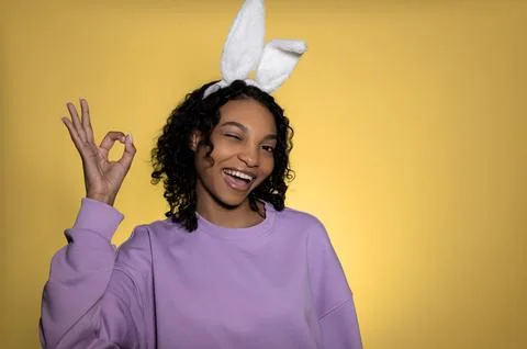 Copyspace easter banner with dark skinned happy model showing ok sign Stock Photos