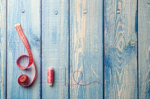 Copyspace frame with sewing tools on the light blue wooden table Stock Photos