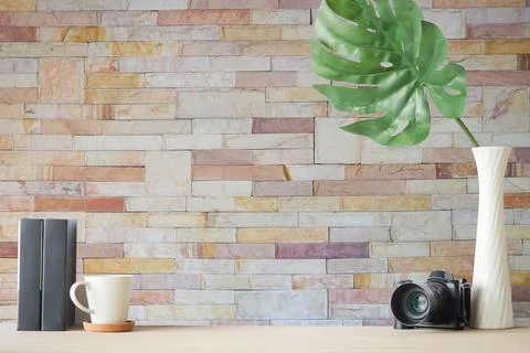 Copyspace of office equipment on white table with stone wall texture backgr.. Stock Photos