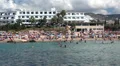 Coral Bay beach with sunbuthing and swimming people. Pegeia, Paphos, Cyprus HD Footage
