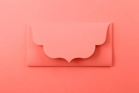 Coral envelope on a orange background. Stock Photos