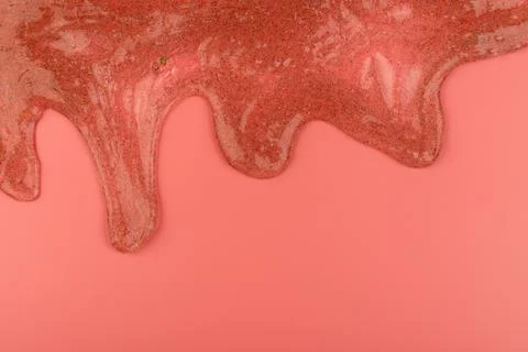 Coral transparent slime with bubbles inside on pink background. Kids toy slim Stock Photos