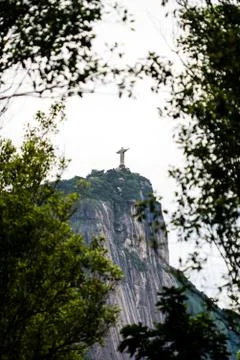 Corcovado statue, christ the redeemer, seen through leaves Stock Photos