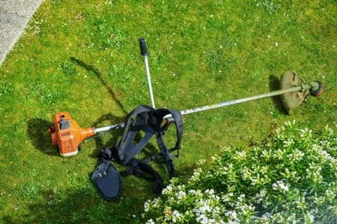 Corded string trimmer in a park Stock Photos