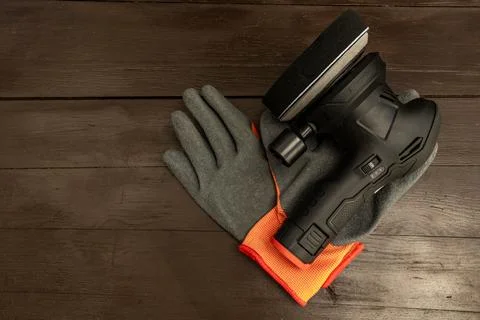 Cordless Angle Grinder with Protective Gloves on Wooden Workbench Stock Photos