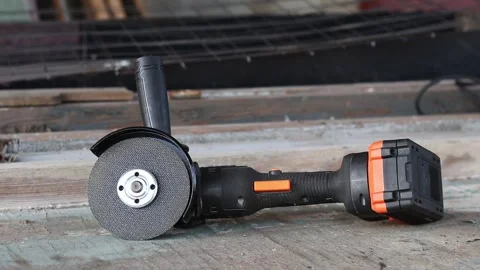 Cordless angle grinder on a wooden table Stock Footage 322651055