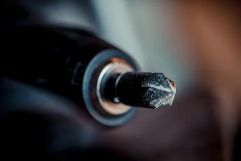 Cordless drill with drill bit after work. Stock Photos