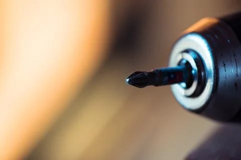 Cordless drill with drill bit after work. Stock Photos