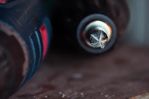 Cordless drill with drill bit after work. Stock Photos