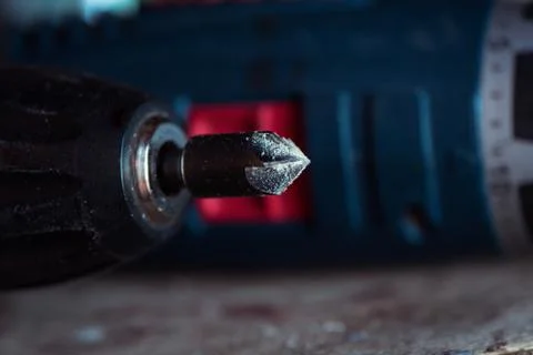 Cordless drill with drill bit after work. Stock Photos