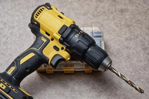 Cordless drill driver with a complete set of drill bits and screwdriver bit.. Stock Photos