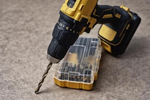 Cordless drill driver with a complete set of drill bits and screwdriver bit.. Stock Photos